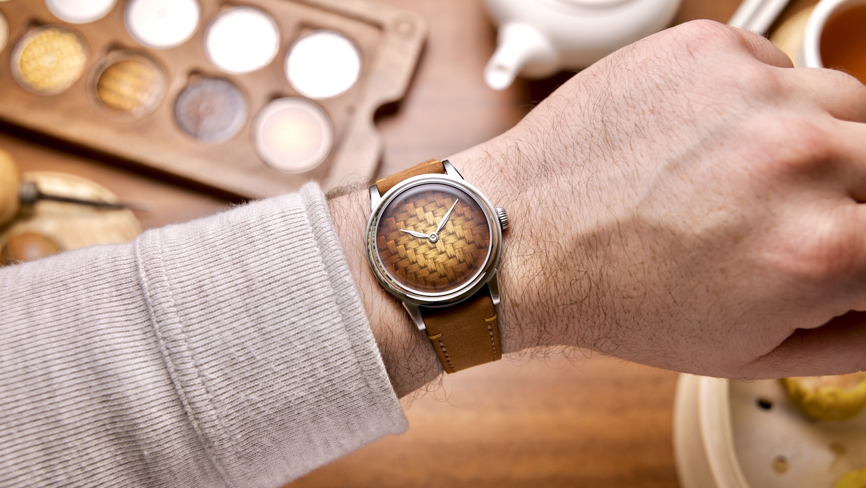Selten Yum Cha watch with an amber enamel bamboo-weave dial and tea-leaf-shaped hands