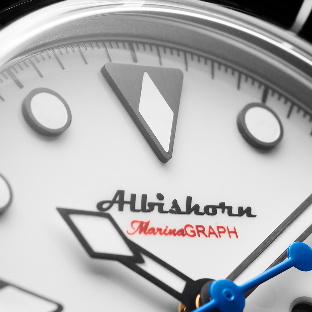 Macro of the Albishorn Marinagraph Classic Fume dial signature and applied markers
